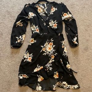 Black floral knee length dress. Wrap style dress.